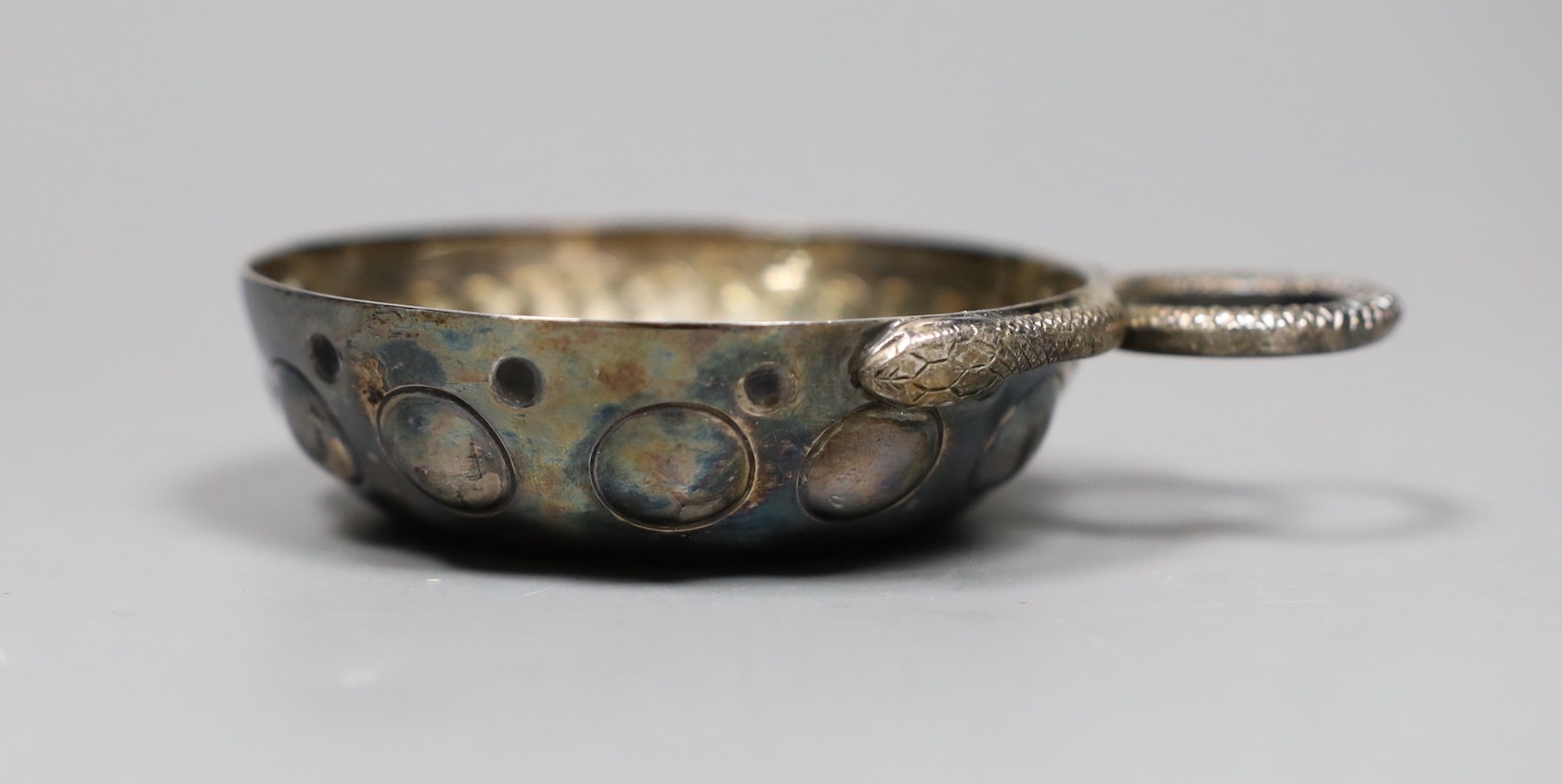 An early 20th century French white metal taste vin, 10cm over handle.